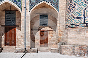 Uzbek carved wooden doors to Kukeldash Madrasah with pattern decorated with oriental arabic carved ornaments in