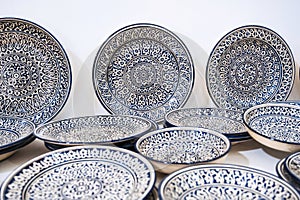 Uzbek handmade ceramic plate with hand-painted Islamic pattern in pottery workshop in Uzbekistan