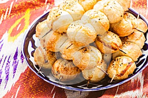 Uzbek national food Samsa on traditional fabric adras