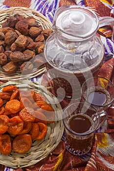 Uzbek national food on traditional fabric adras