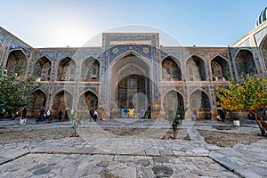 Uzbek religious architecture in facade of ancient Tilya-Kori madrasah with colorful ornament on brick walls