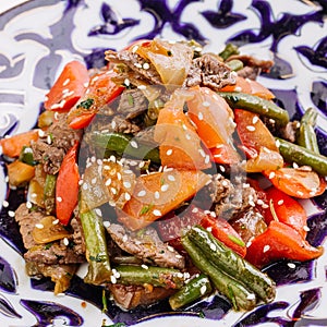 Uzbek salad made of grilled cut vegetables and meat .Uzbek cuisine