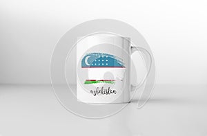 Uzbekistan flag on white coffee mug.