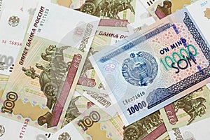 A Uzbekistan som bank note with Russian one hundred ruble bank notes