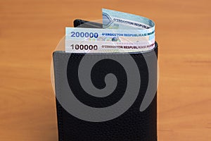Uzbekistani sum in the black wallet