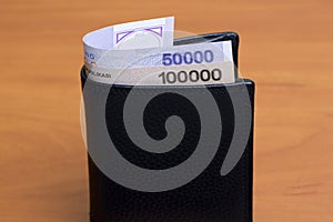 Uzbekistani sum in the black wallet