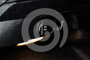 12V power charger plug inside car. Close up of the car cigarette lighter socket