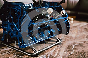 V8 Engine block table, painted in blue color.