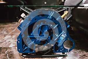 V8 Engine block table, painted in blue color.