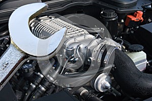 V8 supercharged car engine and spanner