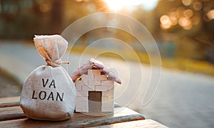 Va loan concept - government-backed mortgage option available to Veterans, service members and surviving spouses. Money bag and