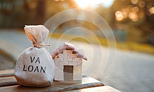 Va loan concept - government-backed mortgage option available to Veterans, service members and surviving spouses. Money bag and photo