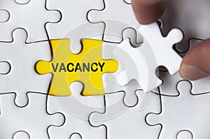 Vacancy text on missing jigsaw puzzle. Employment and hiring concept