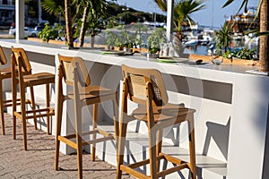 vacant bar chairs at seaside restaurant