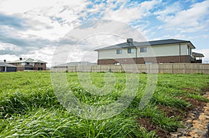 Vacant land next to some residential suburban houses. Melbourne VIC Australia