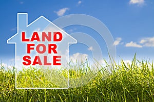 Vacant Land for Sale text in a rural scene over a small home background - Real Estate concept with green wild grass on sky