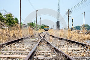 Vacant Rail way switch track with yellow die grass.
