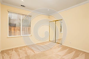 A vacant room with cream walls and beige carpet. Great for virtual staging