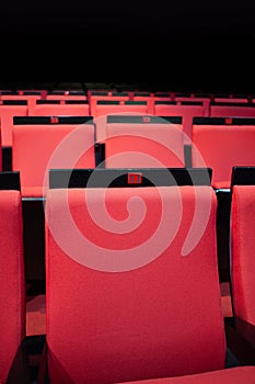 vacant theater with red seats