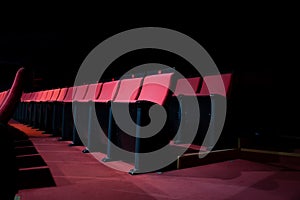 vacant theater with red seats