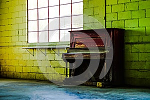 Vacant warehouse window and piano