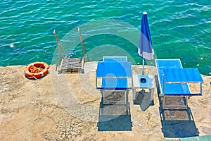 Vacante beachchairs next to the sea photo