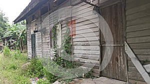 The vacated exterior old wooden building wall texture and fixture.