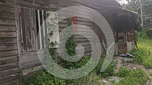 The vacated exterior old wooden building wall texture and fixture.