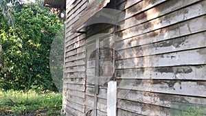 The vacated exterior old wooden building wall texture and fixture.