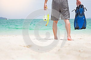 Vacation Backside of man holding snorkeling gear on tropical on