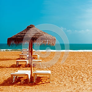 Vacation Beach. Beach chairs umbrellas on the ocean