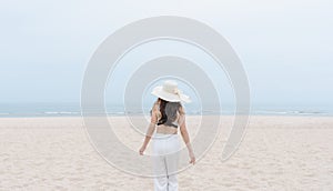 Vacation on the beach, Young woman walking on the beach in summer