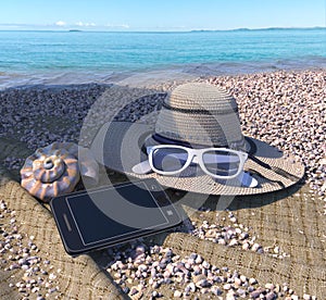 vacation concept background with seashell, iphone and beach accessories