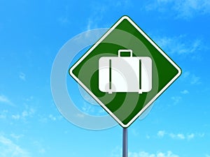 Vacation concept: Bag on road sign background