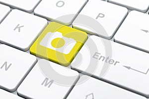 Vacation concept: Photo Camera on computer