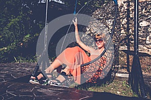 Vacation concept. Young woman swing on tropical island Nusa Lembongan, Bali, Indonesia.