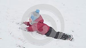 vacation, game, family concept - slo-mo authentic Two happy preschool toddler kids siblings slide down the hill and help