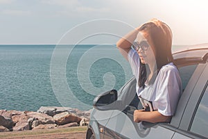 Vacation and Holiday Concept : Happy family car trip at the sea, Portrait woman wearing sunglasses and feeling happiness.