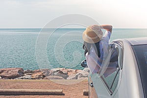 Vacation and Holiday Concept : Happy family car trip at the sea, Portrait woman wearing weave hat and feeling happiness.