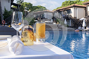 Vacation at the hotel, table setting. empty glasses on the background of the pool and the villas of the hotel. service of guests