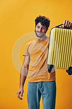 Suitcase man vacation young trip happy yellow tourist holiday journey travel person