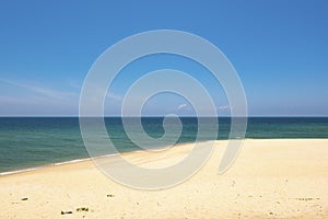 Beautiful tropical beach, soft wave hitting sandy beach under bright sunny day