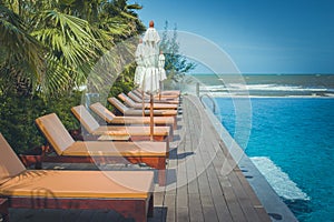 Vacation and Relaxation Concept : Daybed beside swimming pool in the resort.