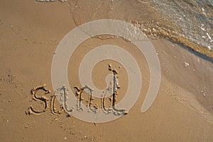 Vacation on the sand beach concept. Sand words written into the sand on the beach at Rayong, Thailand