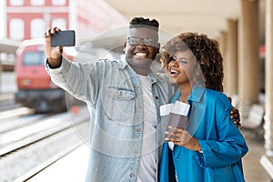 Vacation Selfie. African American Couple Taking Photo With Smartphone At Railway Station