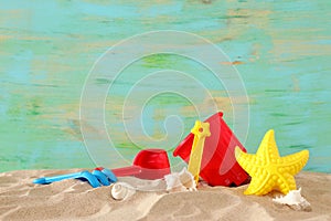 Vacation and summer image with beach colorful toys for kid over the sand