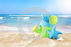Vacation and summer image with beach colorful toys for kid over the sand