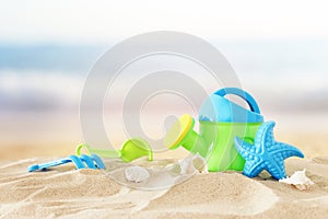 Vacation and summer image with beach colorful toys for kid over the sand