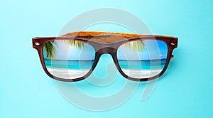 vacation and summer travel banner concept on tropical sea. sunglasses with a reflection of the sandy trovic beach and palm trees