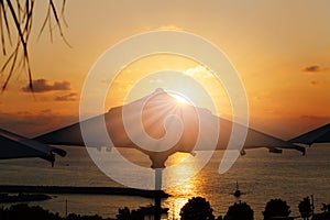 Vacation time: Amazing dawn with parasol and palms